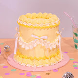 Vintage Cake - Tonal Colour by Crumbs & Doilies, tall 6-layer sponge cake with yellow Swiss Meringue icing and ribbon accents.